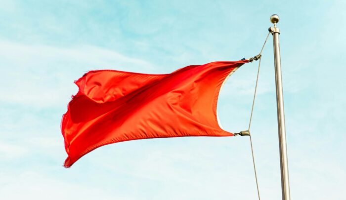 Image of a red flag blowing in the wind