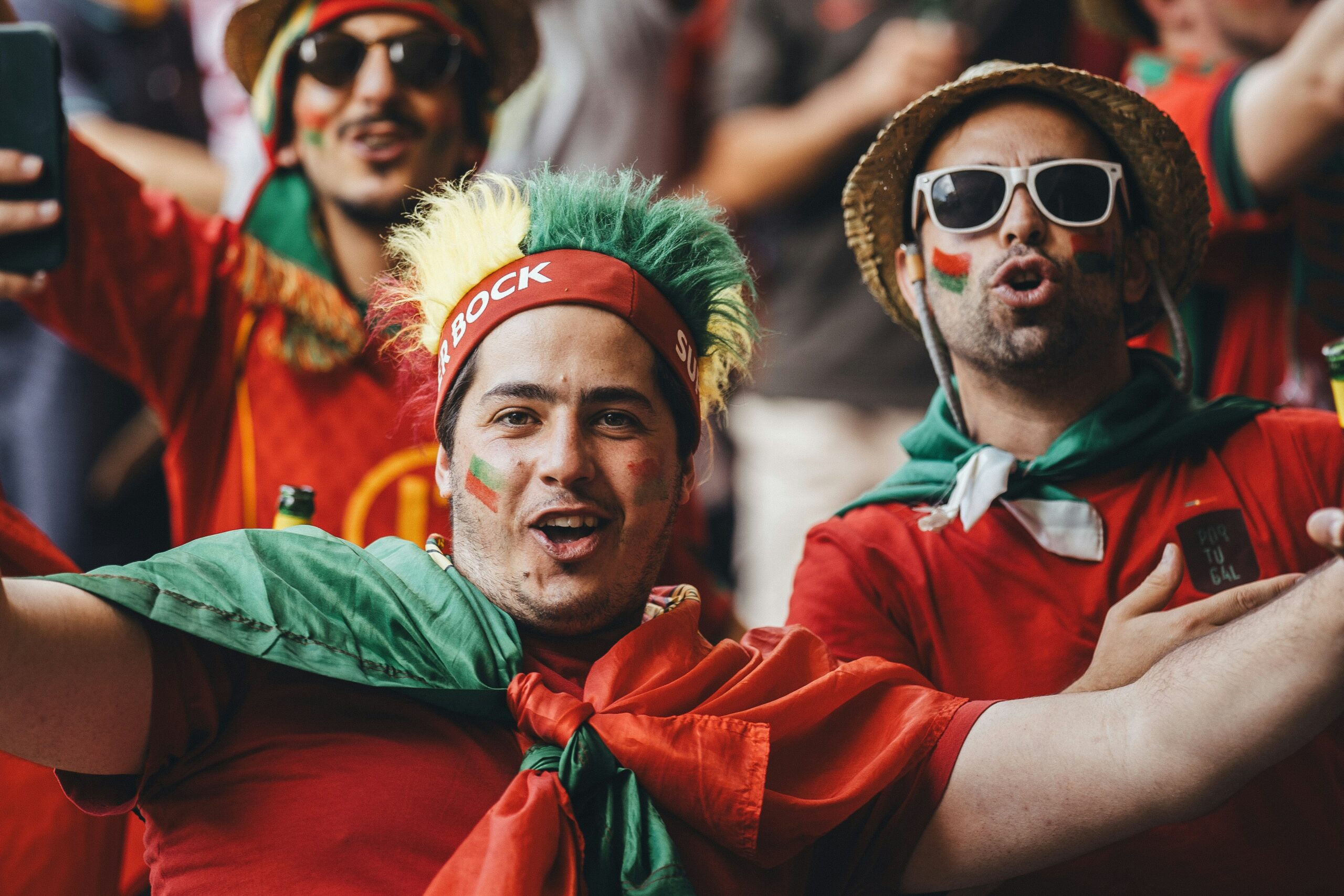 Football fans wearing red jersey cheering