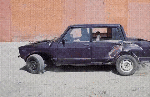 A GIF of a car with wheels faling off