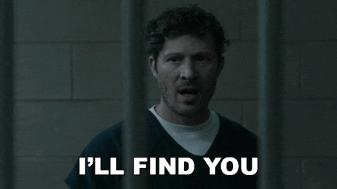 A man behind the bars in jail saying I'll find you, in GIF format